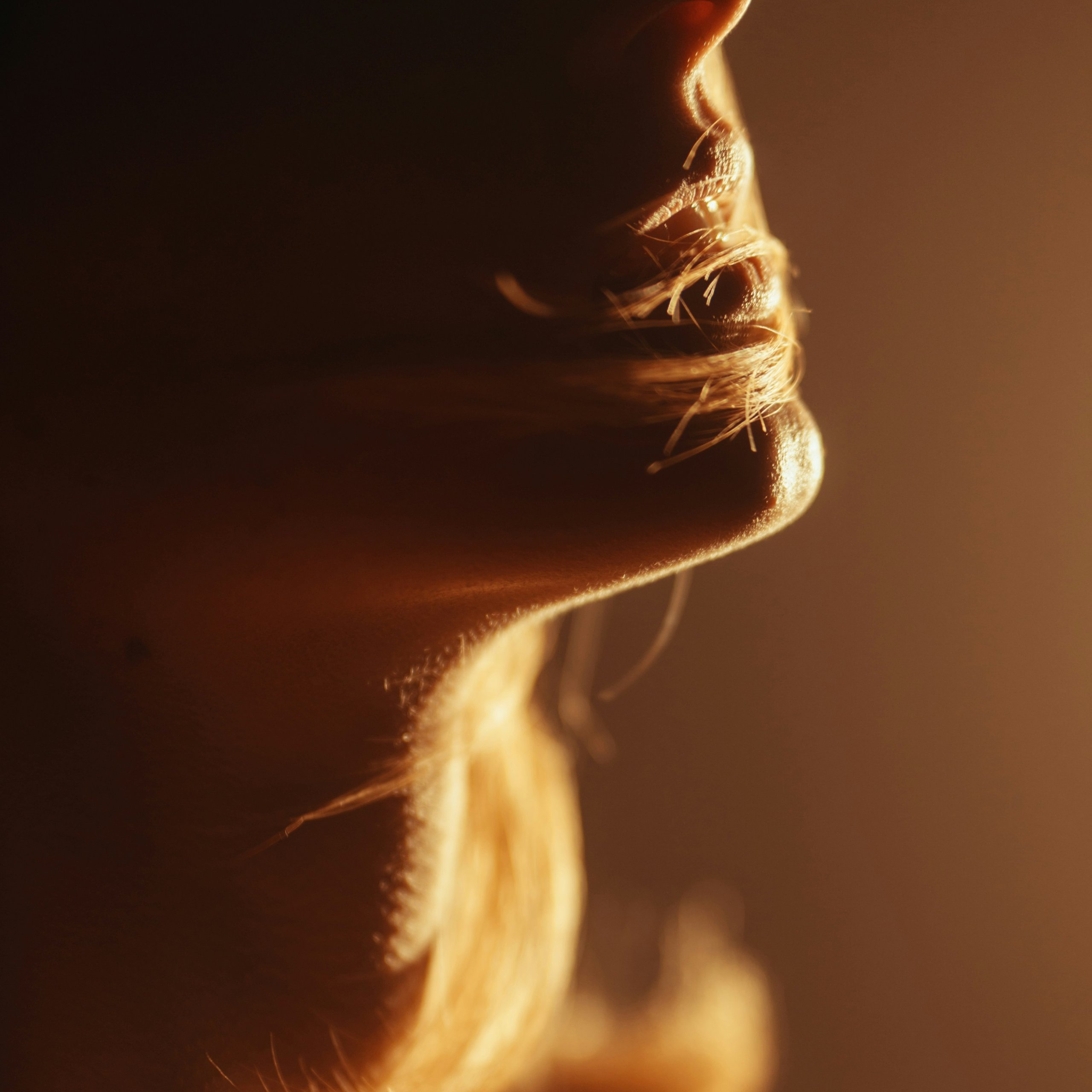 Warm firelight on a woman's profile during an evening workshop